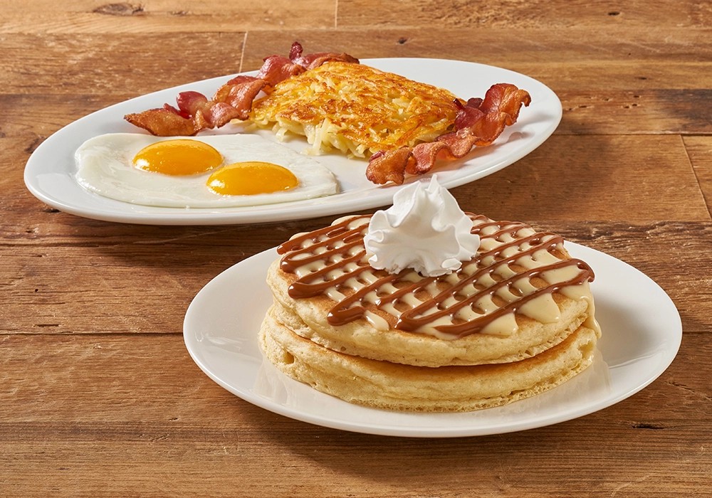 IHOP pancakes with butter, syrup, eggs, and bacon